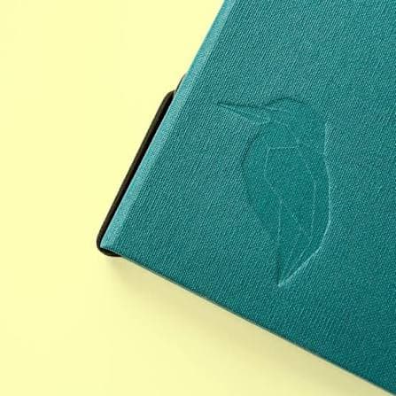 Teal cover with the eisvøgel kingfisher mark blind-embossed into the cotton.
